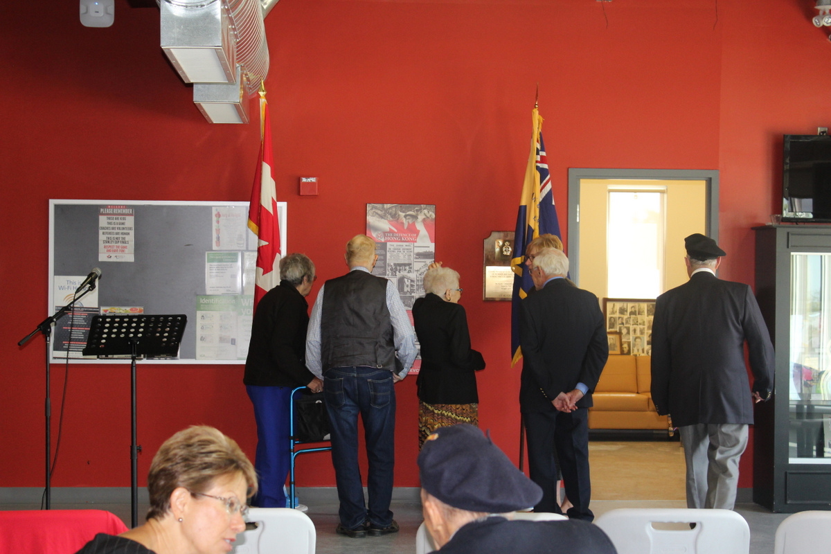 Attendees viewing the plaque